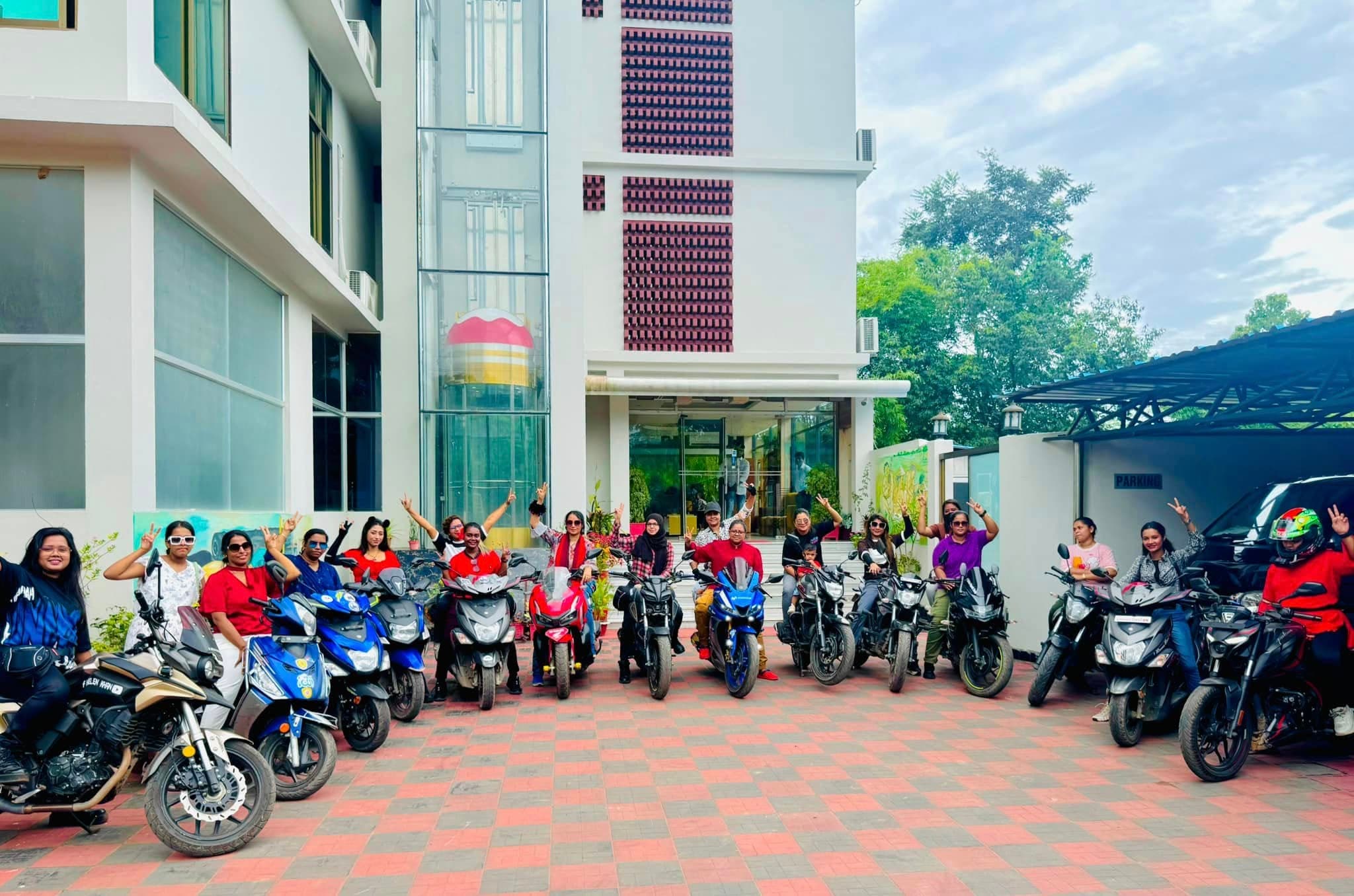 Bikers gathered with their motorcycles outside a hotel on a tour.