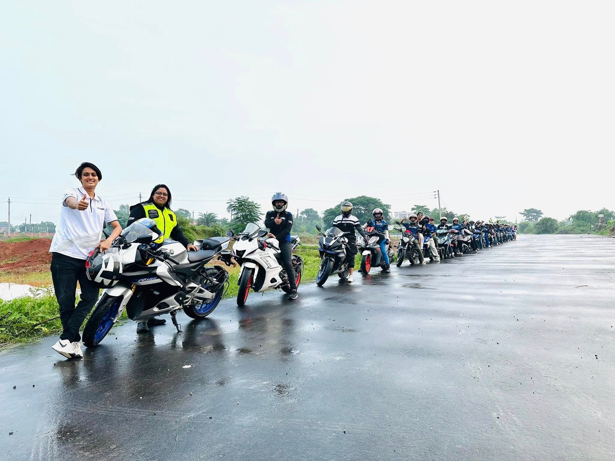 A line of motorcycles and riders in the rain on a group tour.