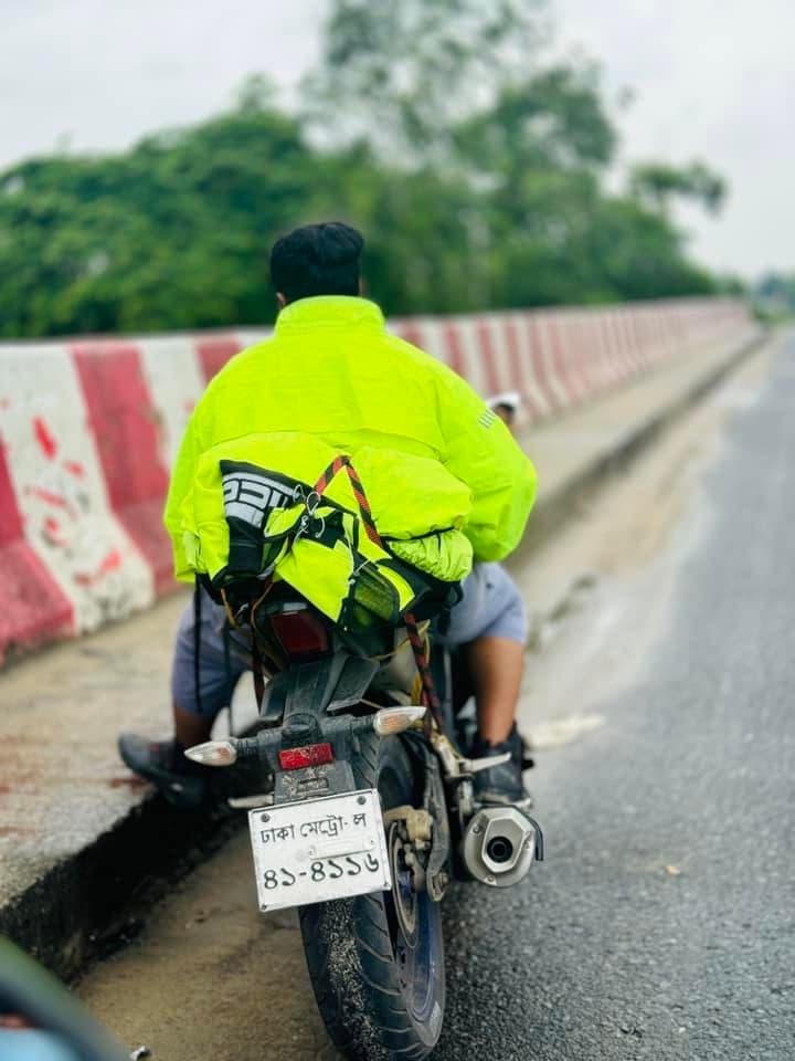 A rider viewed from behind, touring on a motorcycle.