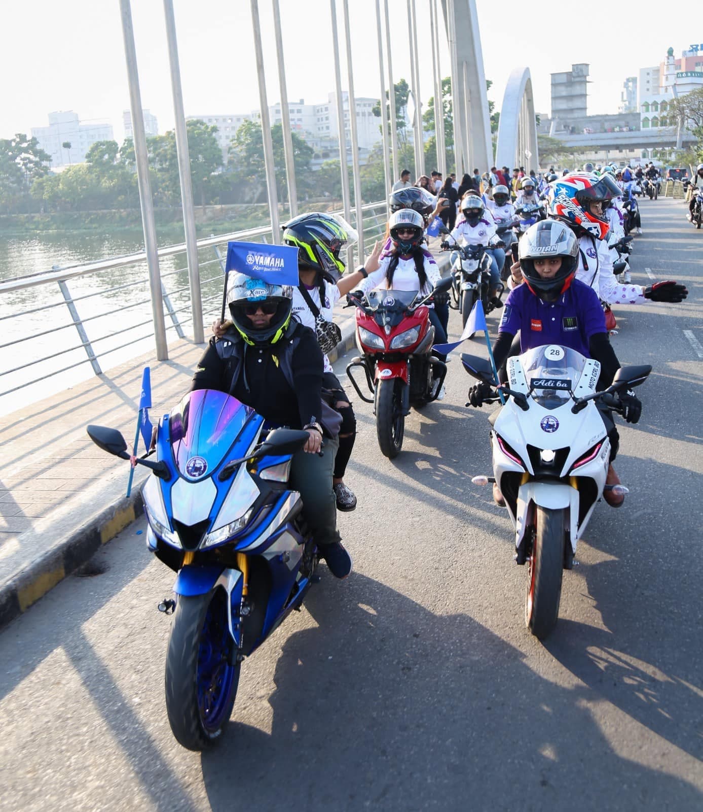 Riders crossing a bridge in a Women's Day rally.
