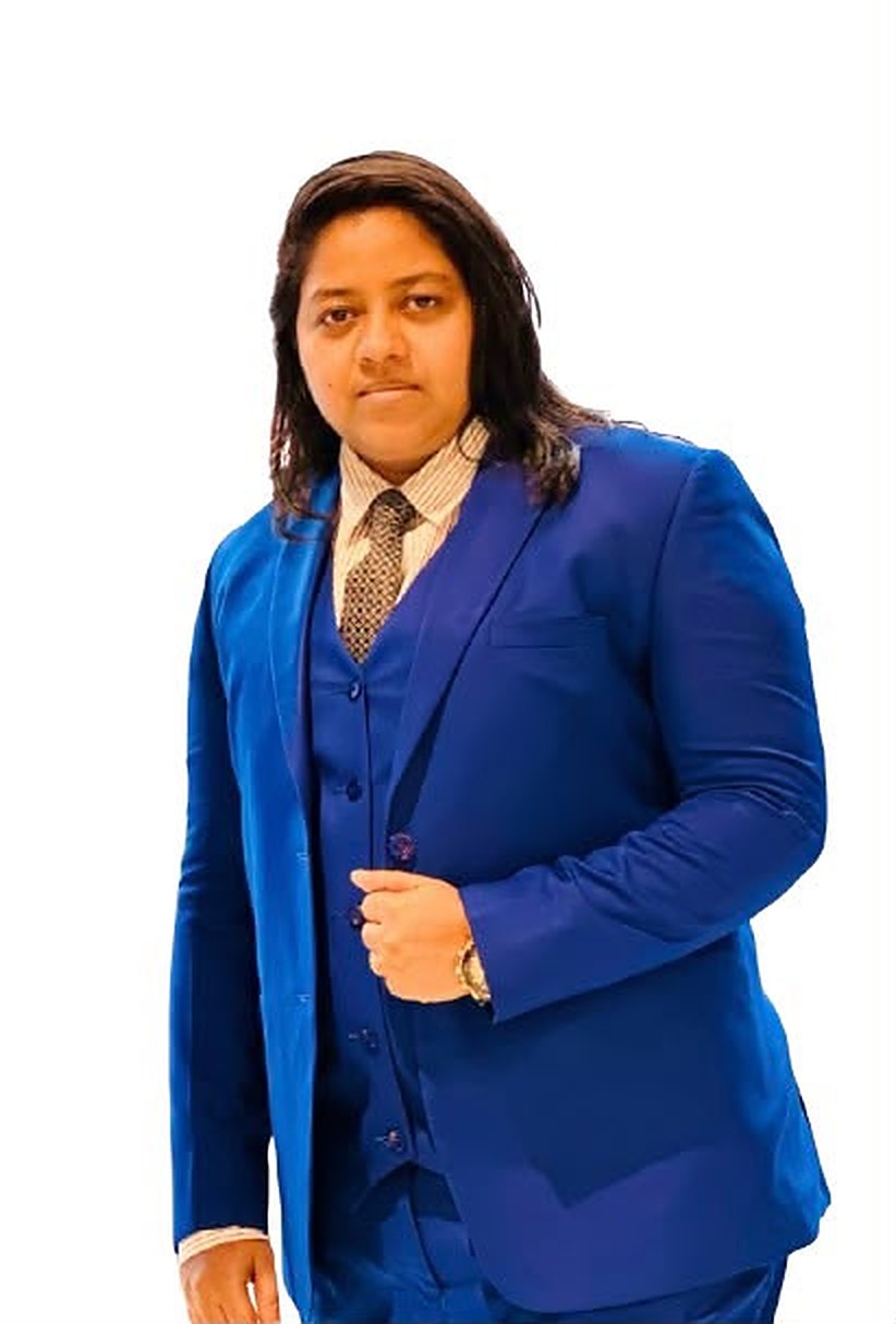 Full-length portrait of Razia Sultana Lina in a blue suit.